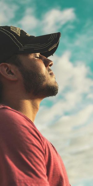 Side profile of a person breathing deeply in a calm space.